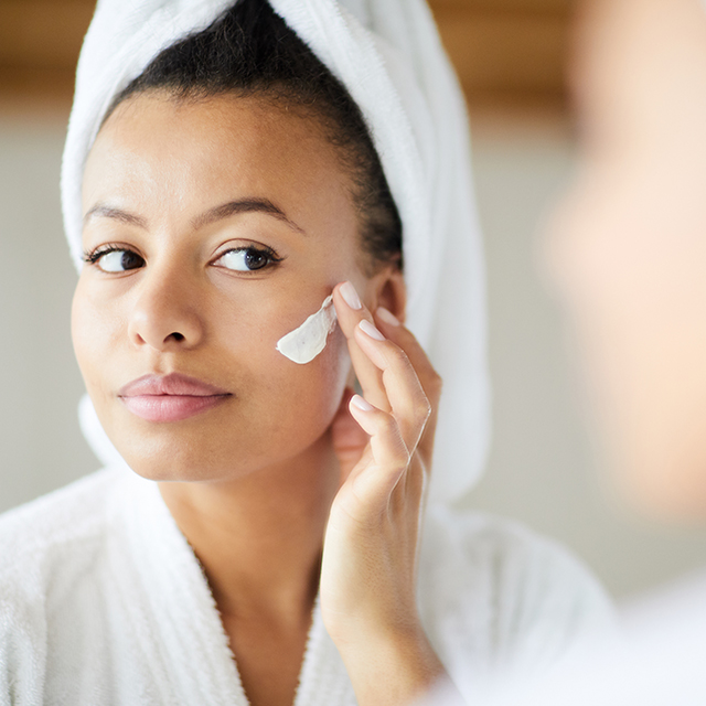 Mixed Race Woman Applying Face Cream